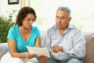 Customers looking over loan documents at home